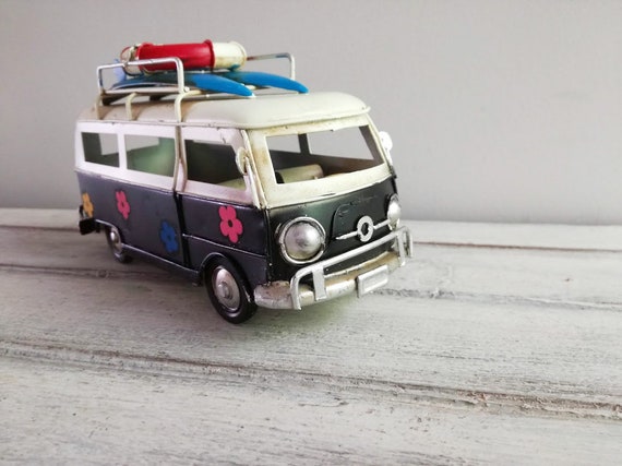 Retro hippie van, hippie van in blue black and white with painted flowers and surfboards on the baggage rack, collectible van miniature