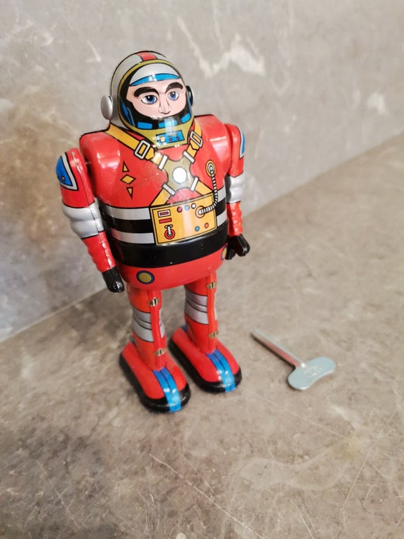 Astronaut robot toy, wind up toy of tin astronaut in red suit, collectible vintage astronaut toy