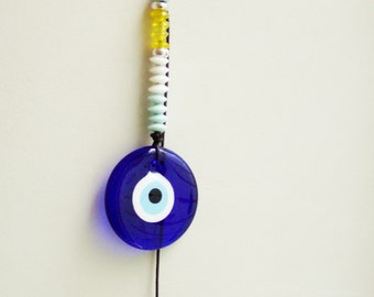Blue eye house charm, hand blown glass eye in night blue with black cord and white, blue, yellow beads, traditional, Greek folk art