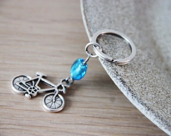 Silver bicycle keychain, alloy bike charm with blue glass bead key ring, unisex key holder with bicycle and blue bead, bicycle gift