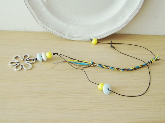 Flower boho necklace, alloy flower, beaded necklace on black cord with braided fiber section, white, yellow, blue and black, boho neklace