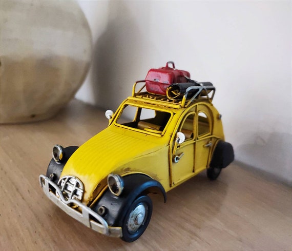 French car miniature, vintage French yellow, retro collectible miniature with black fenders and baggage on the rack, yellow retro car gift