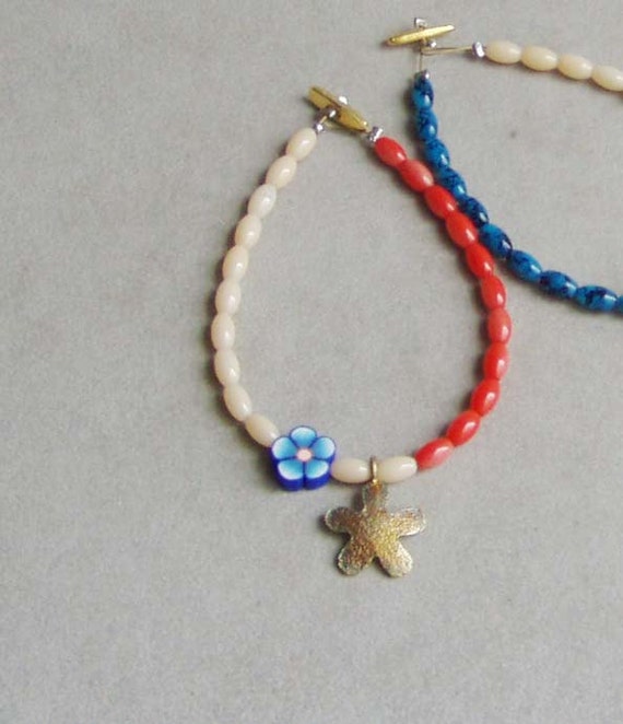 Colourful beaded bracelet, red, cream and blue bracelet with brass flower, spring colours bracelet for girls and teeens