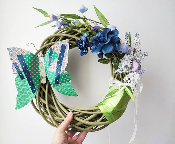 Butterfly wicker wreath, metal butterfly and artificial flowers on thick, wicker, green wreath