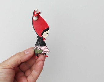 Red Riding Hood brooch, wooden brooch of Red Riding Hood in profile with long, red hood, black vest and basket in hand, teens beaded brooch