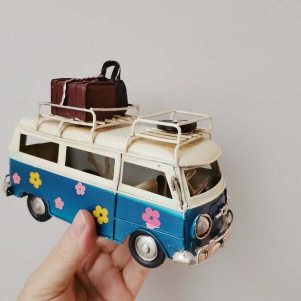 Retro van miniature, hippie van in royal blue and white with painted flowers and suitcases on baggage rack