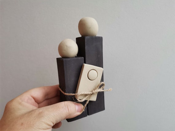 Abstract ceramic family, father mother child complex in beige and black, two clays family of three sculpture in one piece