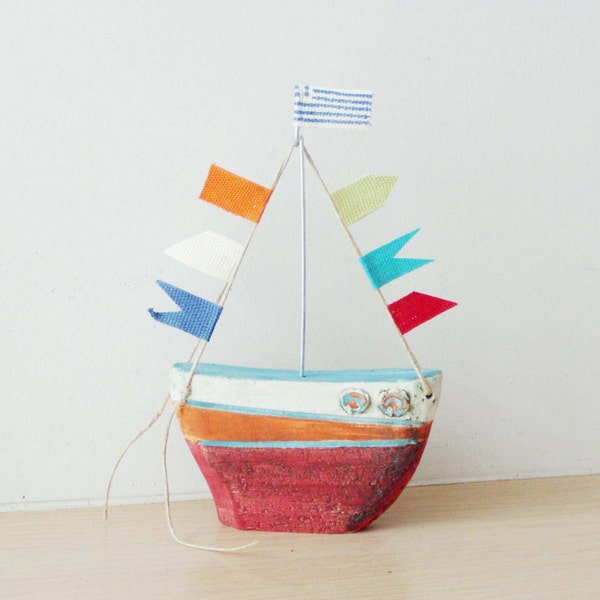 Ceramic sailing boat with colourful flags, stoneware clay boat outline sculpture with wire mast and fabric flags