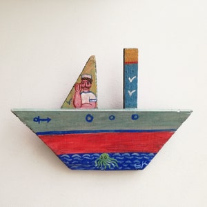 Sailor on wooden boat, folk art shabby boat of reclaimed wood, salvaged, old wood folk boat with Greek sailor painted, Greek folk art