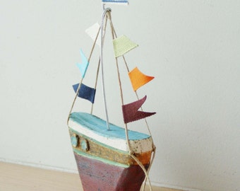 Ceramic sailing boat with colourful flags, stoneware clay boat sculpture with wire mast and fabric flags, Greek pottery boat