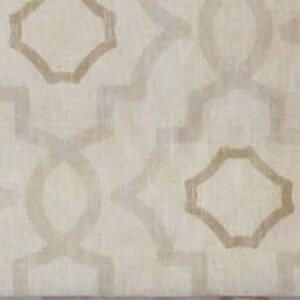 May include: A white fabric with a beige geometric pattern. The pattern is made up of repeating octagons and lines.