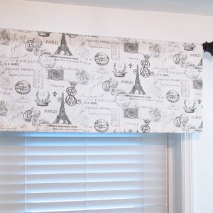 May include: A white valance with a black and white print of the Eiffel Tower, stamps, and the words "Paris" and "Provot Frères".