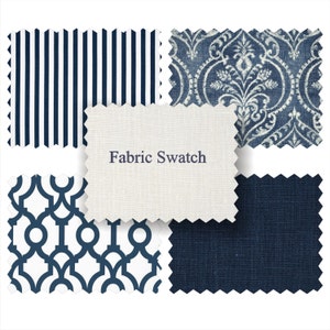 May include: Fabric swatches in four different patterns: a white and navy blue striped pattern, a white and navy blue geometric pattern, a navy blue solid fabric, and a white and navy blue damask pattern. The text "Fabric Swatch" is printed on a white fabric swatch.