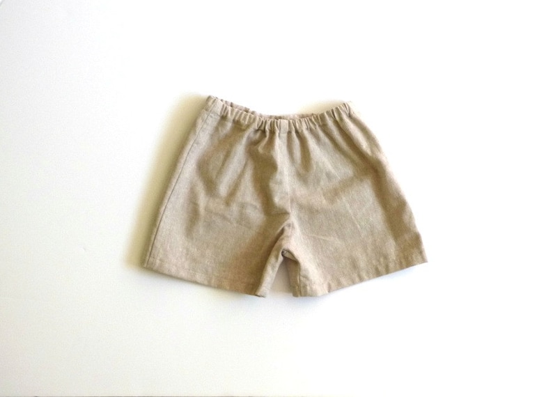 May include: A pair of beige linen shorts with an elastic waistband.