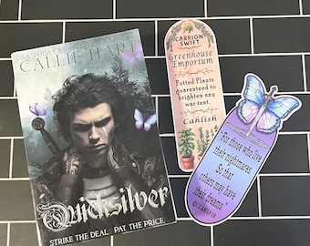 May include: A paperback book titled "Quicksilver" by Callie Hart with a dark fantasy cover featuring a young man with a sword and butterflies.  The book is next to two bookmarks. One bookmark is a purple and blue pill-shaped bookmark with a butterfly and a sword. The other bookmark is a green and brown bookmark with a potted plant and the text "Carrion Swift Greenhouse Emporium".