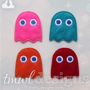 May include: Four felt ghost shapes with blue eyes. The ghosts are pink, teal, orange, and red.