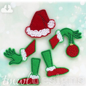 May include: A set of felt Christmas elf applique pieces, including a hat, arms, legs, and a Christmas ornament. The pieces are green and red with white trim.