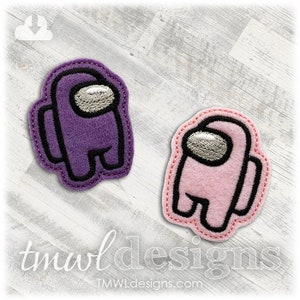 May include: Two felt patches in the shape of the popular video game character, Among Us. One patch is purple and the other is pink.