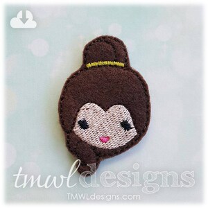 May include: Embroidered felt applique of a brown-haired girl with a yellow headband. The girl has a pink nose and black eyes.