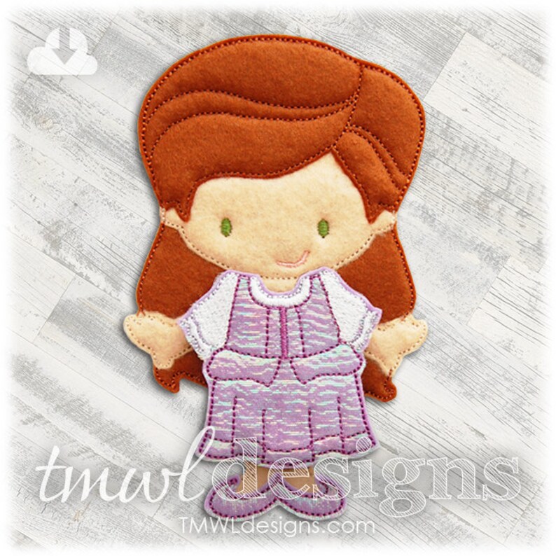 May include: A felt applique of a girl with long brown hair, wearing a purple dress with a white bodice. She has green eyes and a smiling face.