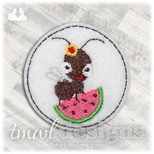 May include: Embroidered patch featuring a cartoon ant with a watermelon slice. The ant is brown with a red mouth and a yellow and red flower on its head. The patch is round with a black stitched border and a white background.