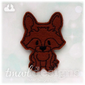 May include: A brown felt fox applique with black embroidered details. The fox is sitting with its paws together and has a cute, cartoon-like expression.