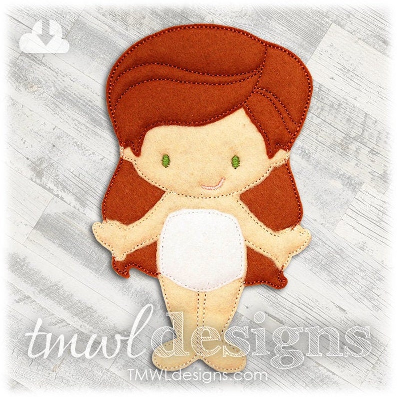 May include: A felt doll with red hair, a white dress, and green eyes. The doll is standing on a wooden surface.