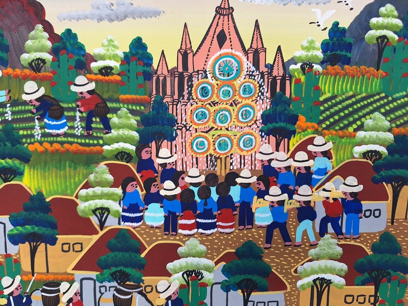 May include: A colorful painting depicting a village scene with a large pink church in the background. People in blue and red clothing are gathered in front of the church, while others are working in the fields. The painting is done in a naive style with bright colors and simple shapes.