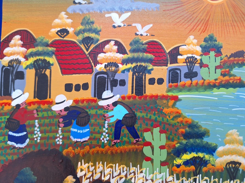 May include: A colorful painting depicting a rural scene with houses, trees, a river, and people working in a field. The houses are yellow with red roofs and white windows. The trees are green and the river is blue. The people are wearing hats and traditional clothing. The painting is done in a folk art style.