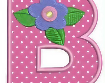May include: A pink letter B with a white polka dot pattern and a raised border. A purple flower with a pink center and two green leaves is attached to the top section of the letter. The object has a smooth, matte finish and a flat, blocky shape.