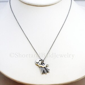 May include: A silver chain necklace with a silver pendant featuring a stylized bird design.