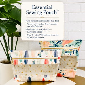 May include: Two sewing pouches with clear vinyl windows and gold zippers. The front pouch features a white fabric with colorful abstract shapes, while the back pouch has a floral pattern. Text reads: Essential Sewing Pouch, No exposed seams, Clear vinyl window, Includes two useful sizes, Step-by-step PDF pattern.