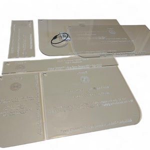 May include: A set of clear acrylic templates for making face shields. The templates are labeled with instructions and include a logo for "Zippy Creations".