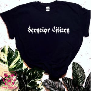 May include: Black t-shirt with the text "Senior Citizen" in white gothic lettering.