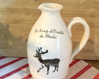 Jug for maple syrup with a deer. French inscription "Le Pichet à Sirop du Chalet". Handmade porcelain, Silkcreened image