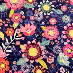 May include: A navy blue background with a repeating pattern of pink, red, yellow, and blue flowers. The flowers are stylised and have a whimsical feel.