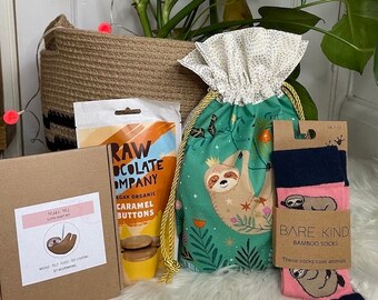 Prefilled sloth gift bag, which contains a craft kit, bamboo socks, and caramel buttons