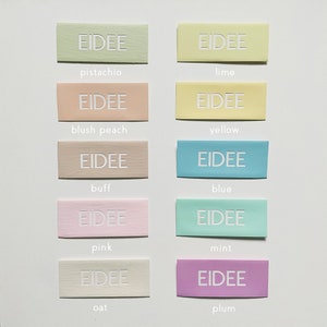 May include: A collection of rectangular labels in various pastel colors, each with the word "EIDEE" embossed in white. Colors include pistachio, lime, blush peach, yellow, buff, blue, pink, mint, oat, and plum. The labels are arranged in rows and columns.