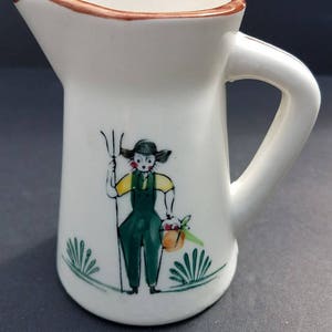 Small Creamer with handle - hand painted Farmer Holding a Rake and Bucket