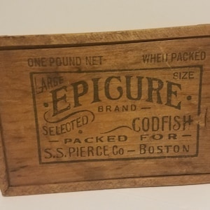 May include: A wooden box with a label that reads "One Pound Net - Large Epigure Brand - Selected Codfish - Packed For - S.S. Pierce Co - Boston".