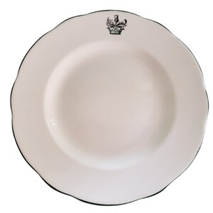 May include: White ceramic soup bowl with a green rim and a black and white thistle design.