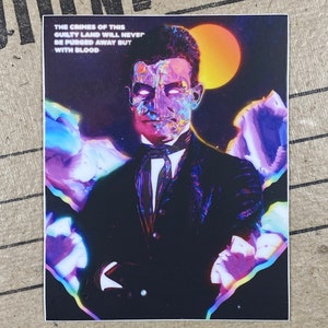 May include: A digital art print featuring a man with a colorful, abstract face. The background is a dark blue with a bright orange sun and purple and blue clouds. The text "The crimes of this guilty land will never be purged away but with blood" is printed at the top of the image.