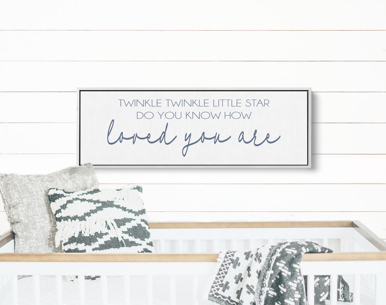 May include: A white wooden sign with black trim and a gray background. The sign reads "Twinkle Twinkle Little Star Do You Know How Loved You Are" in blue lettering.