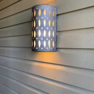 Outdoor Ceramic Wet Location Wall Sconce with Ovals and Holes Cutout - Coastal Lighting and Tropical Decor - Dark Sky Lighting - Metal Glaze