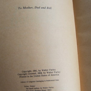 May include: A close-up of the copyright and publishing information for the book "The Black Stallion" by Walter Farley. The book was published in 1941 and the copyright was renewed in 1969.