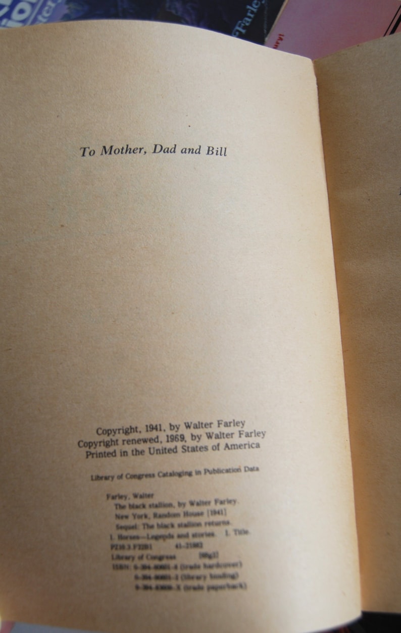 May include: A close-up of the copyright and publishing information for the book "The Black Stallion" by Walter Farley. The book was published in 1941 and the copyright was renewed in 1969.