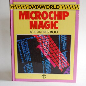 May include: A yellow and pink book cover with the title "Microchip Magic" by Robin Kerrod. The cover features a colorful image of a computer keyboard with numbers and letters displayed on the keys.