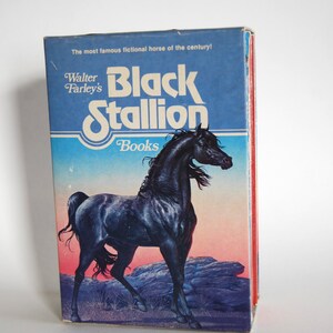 May include: A book cover featuring a black stallion with the title "Black Stallion" and the author "Walter Farley's" in white text. The book cover also includes the text "The most famous fictional horse of the century!" and "Books" in blue text.