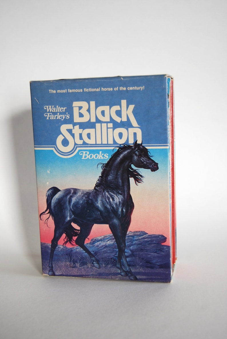 May include: A book cover featuring a black stallion with the title "Black Stallion" and the author "Walter Farley's" in white text. The book cover also includes the text "The most famous fictional horse of the century!" and "Books" in blue text.