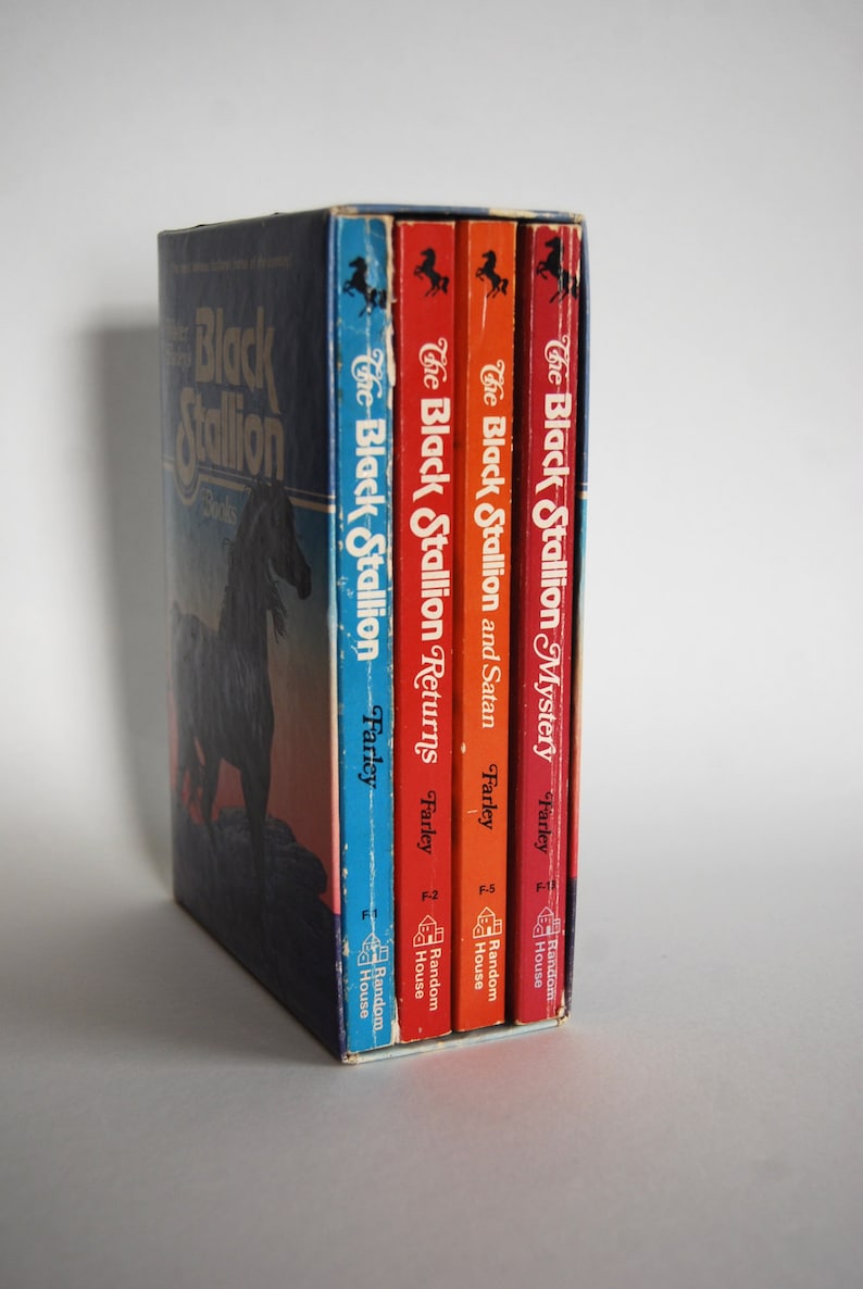 May include: A set of four paperback books in a slipcase. The books are all about The Black Stallion, a famous horse. The books are by Walter Farley and published by Random House.